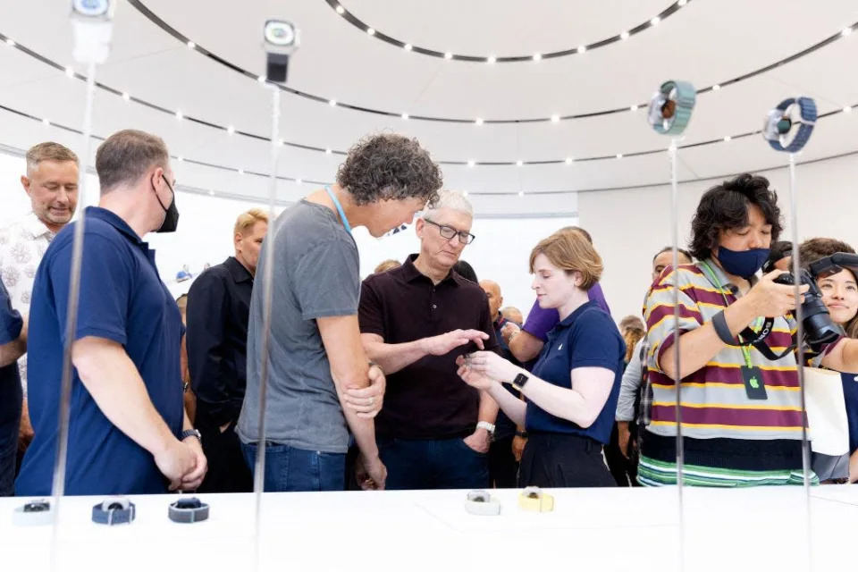 Apple CEO Tim Cook looks over one of the new Apple watches during a launch event for new products at Apple Park in Cupertino, California, on September 7, 2022.