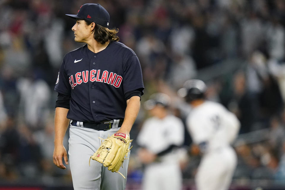 Cleveland Guardians starting pitcher Eli Morgan, left, watches a ball hit by New York Yankees' Aaron Judge, back right, who runs the bases after hitting a two-run home run during the third inning of a baseball game Friday, April 22, 2022, in New York. (AP Photo/Frank Franklin II)