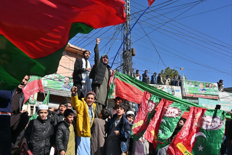 Pakistan Tehreek-e-Insaf (PTI) party activists outside a polling station during Pakistan's general election in Islamabad on February 8, 2024. (AFP via Getty Images)
