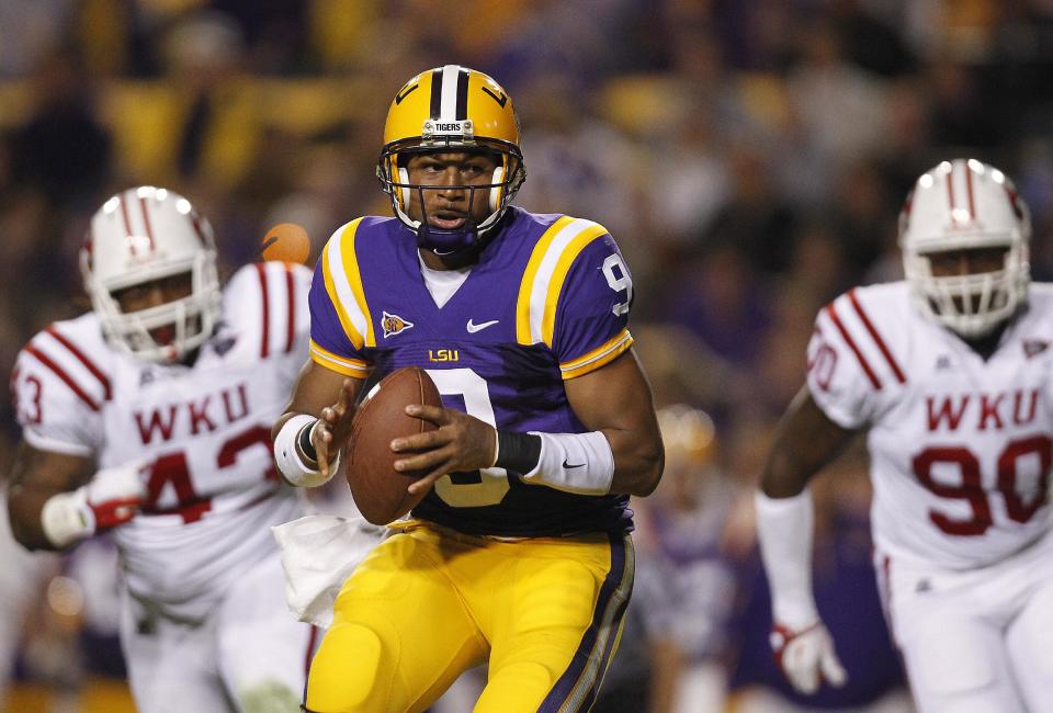 LSU quarterback Jordan Jefferson (9) looks for a receiver as Western Kentucky defensive lineman Jamarcus Allen (43) and defensive lineman Bo Adebayo (90) pursue during the second quarter of their NCAA college football game in Baton Rouge, La., on Saturday, Nov. 12, 2011. (AP Photo/Gerald Herbert)