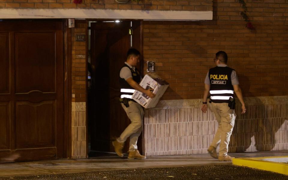 Police leave the president's house with a box