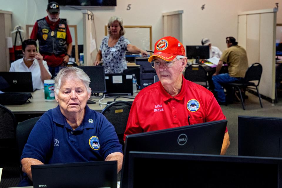 Allen Benton, client and volunteer at the Dale K. Graham Veterans Foundation, works on intake data with Shirley Fisher at the organization's office in Norman