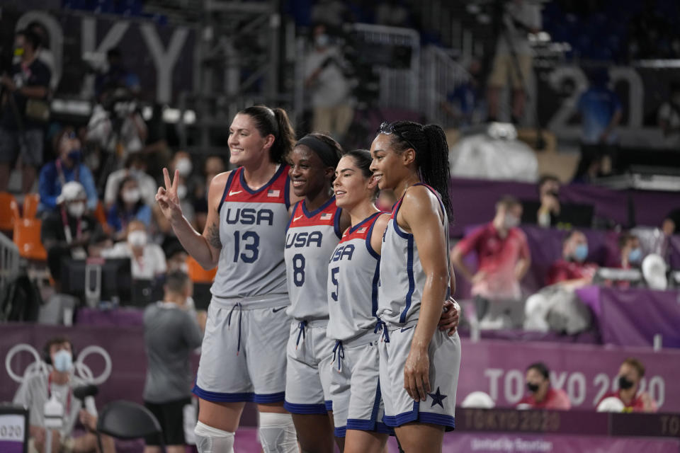 FILE - United States' Stefanie Dolson (13), Jacquelyn Young (8), Kelsey Plum (5) and Allisha Gray celebrate after defeating Russian Olympic Committee in a women's 3-on-3 gold medal basketball game at the 2020 Summer Olympics, Wednesday, July 28, 2021, in Tokyo, Japan. The U.S. learned Wednesday, Nov. 1, 2023, that it has clinched spots at the Paris Games in both men’s and women’s 3x3 basketball. (AP Photo/Jeff Roberson, File)