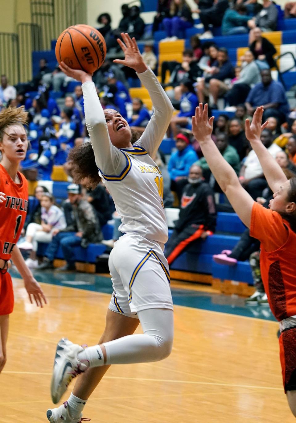 Mainland's Tia Dobson (10) attempts a shot in the lane during a game with Spruce Creek at Mainland High School, Wednesday, Dec. 21, 2022.