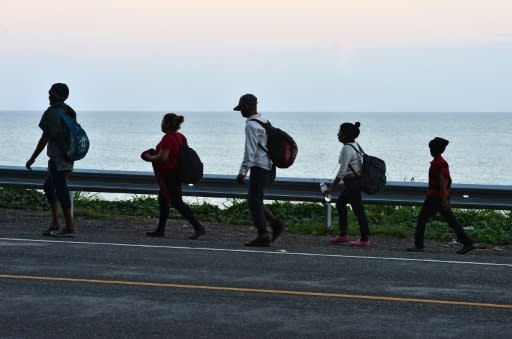 Honduran migrants in the northern coastal town of Omoa make their way to San Pedro Sula to join a caravan heading to the southern US border