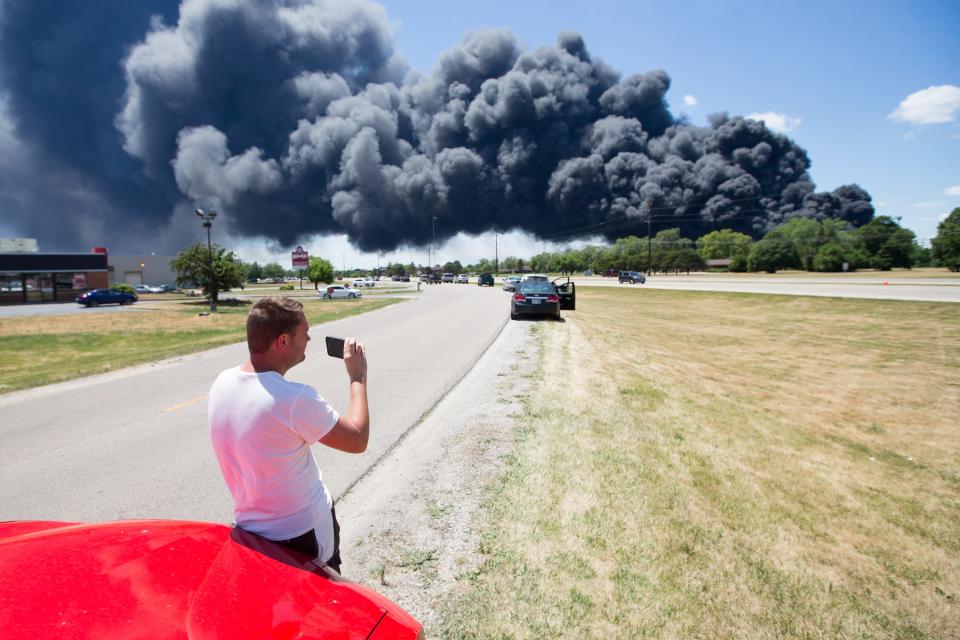 Jeff Phillips watches black smoke cloud billowing over Nazarene Drive Monday, June 14, 2021, in South Beloit, from the massive industrial fire at Chemtool on Prairie Hill Road in Rockton.