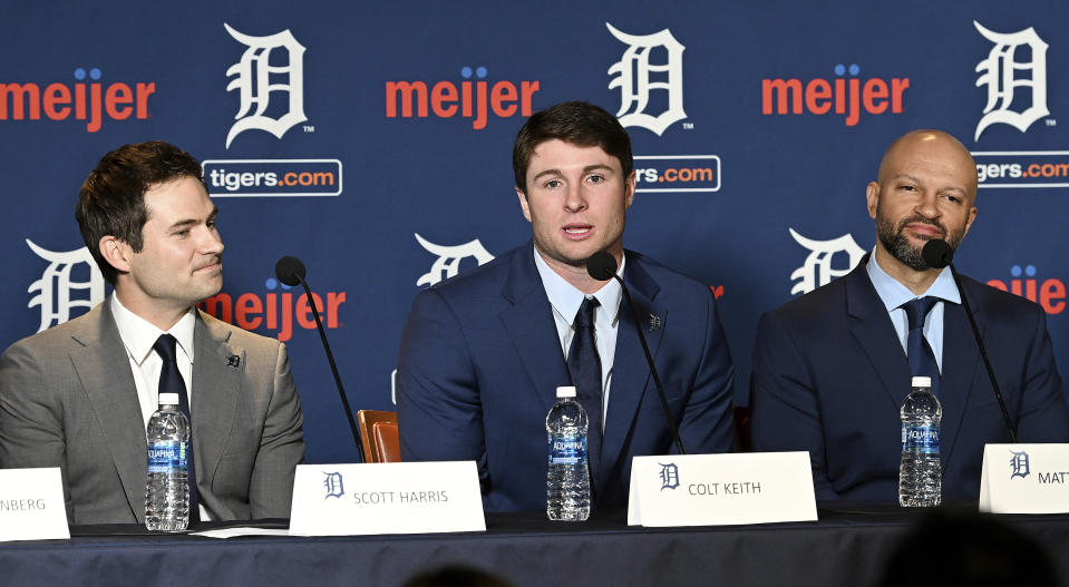 Detroit Tigers president of baseball operations Scott Harris, left, listens as Colt Keith answers a question during a press conference about his contract extension at the MotorCity Casino Hotel Tiger Club in Detroit Tuesday, Jan. 30, 2024. The Detroit Tigers made an unusual bet on a player with no major league experience, agreeing Sunday to a six-year contract with the 22-year-old that guarantees the infield prospect $28,642,500. Keith's agent Matt Paul is at right. (Robin Buckson/Detroit News via AP)