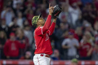 Los Angeles Angels relief pitcher Raisel Iglesias points to the sky, after the Angels defeated the Oakland Athletics 5-3 in a baseball game in Anaheim, Calif., Saturday, May 21, 2022. (AP Photo/Alex Gallardo)