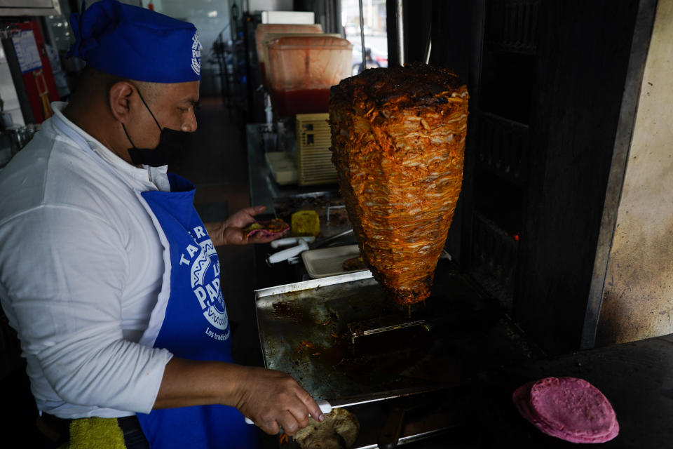 A cook prepares a taco with a Barbie themed pink tortilla at a restaurant in Mexico City, Thursday, July 20, 2023. The restaurant is offering tacos to its customers, made with these Barbie-themed tortillas where the corn dough is colored pink with beet juice. (AP Photo/Eduardo Verdugo)