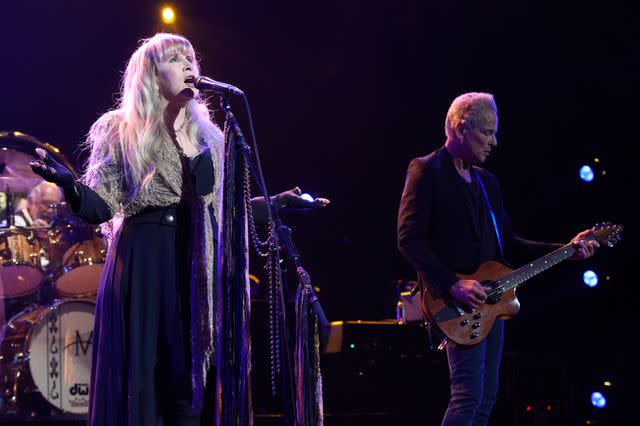 <p>Kevin Mazur/Getty </p> Fleetwood Mac bandmates and exes Stevie Nicks and Lindsey Buckingham perform together in 2018.