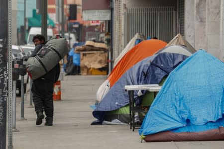 Tents and tarps erected by homeless people are shown along the sidewalks in the skid row area of downtown Los Angeles, California