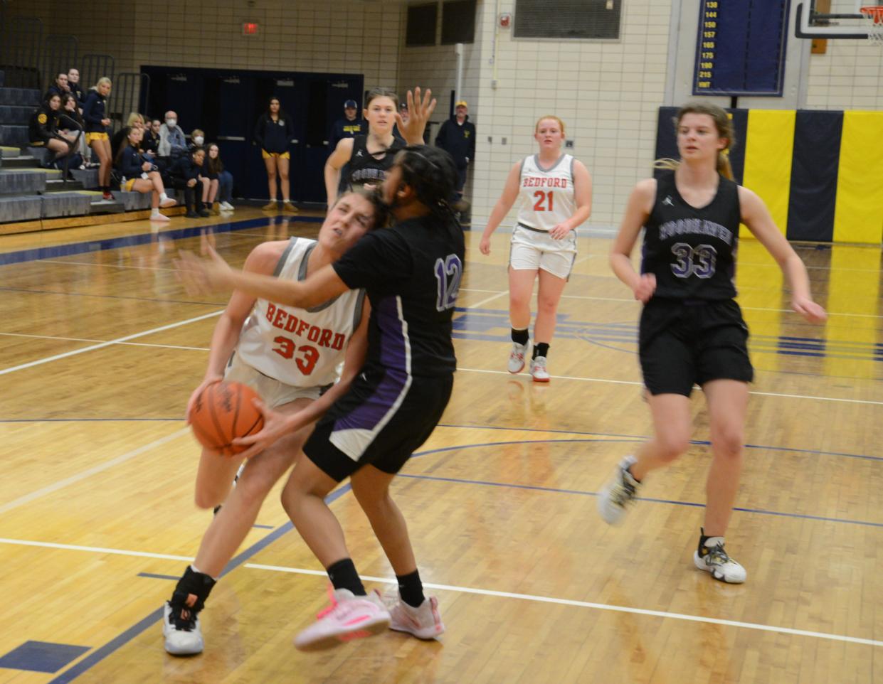 Bedford's Victoria Gray runs into Woodhaven defender Kamari Dabbs Wednesday during a 48-27 Beford win in the semifinals of the Division 1 District at Trenton.