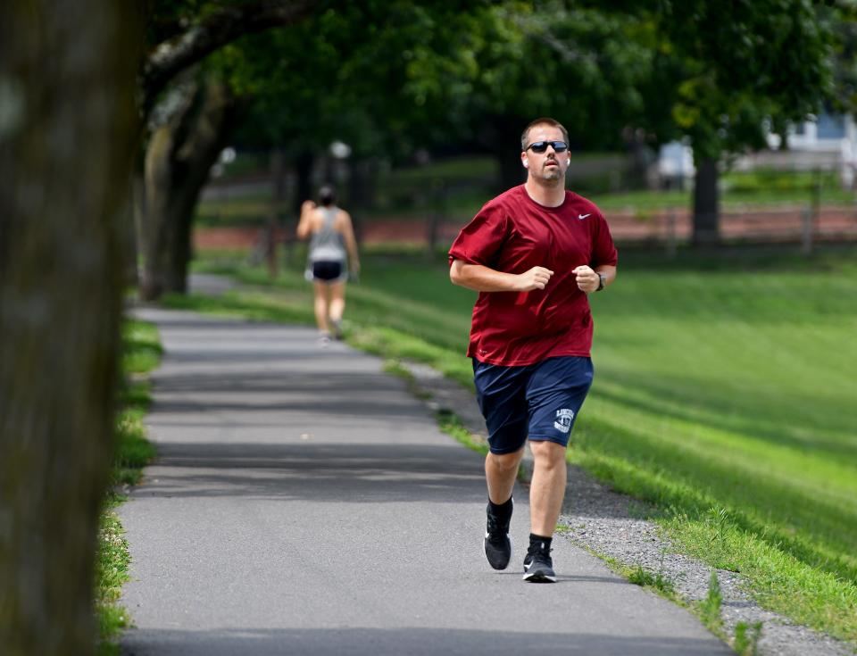 Justin McKay, 39, of Holden jogs at Lake Park on a toasty Thursday.