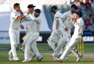 Australia's Adam Voges (C) walks off the ground after he was dismissed by New Zealand's Trent Boult (L) for 28 runs during the third day of the third cricket test match at the Adelaide Oval, in South Australia, November 29, 2015. REUTERS/David Gray