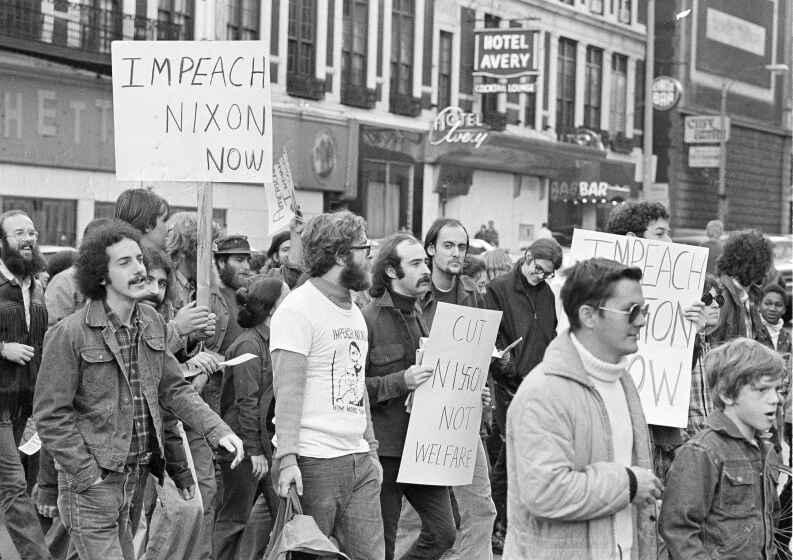 About 200 demonstrators paraded downtown Boston, Oct. 23, 1973 to urge the impeachment of President Nixon. The marchers said they were a coalition of groups who have banded together to for the Committee to Remove Our President. (AP Photo/J. Walter Green)