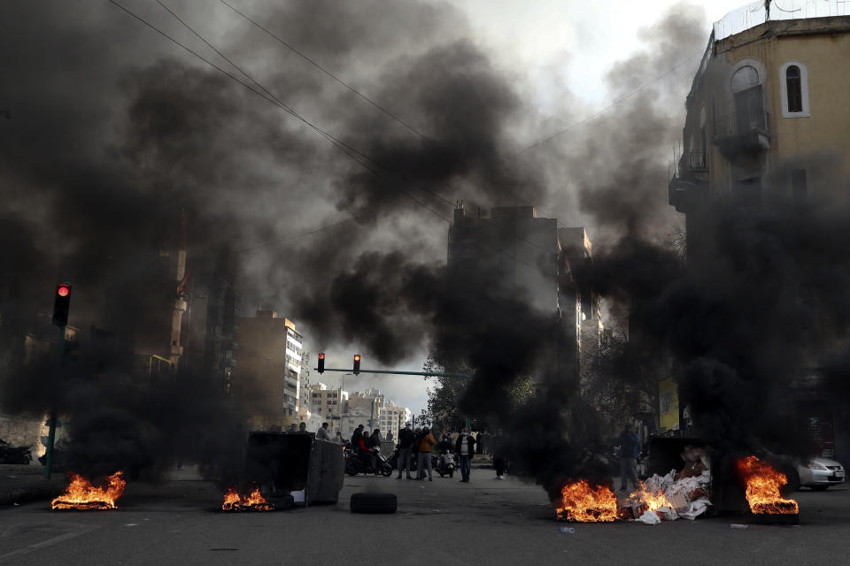 Protesters burn tires to block a road, during a protest in Beirut, Lebanon, Thursday, March 4, 2021. Lebanon has been hit by one crisis after another, with widespread protests against the country’s corrupt political class breaking out in October 2019. (AP Photo/Bilal Hussein)