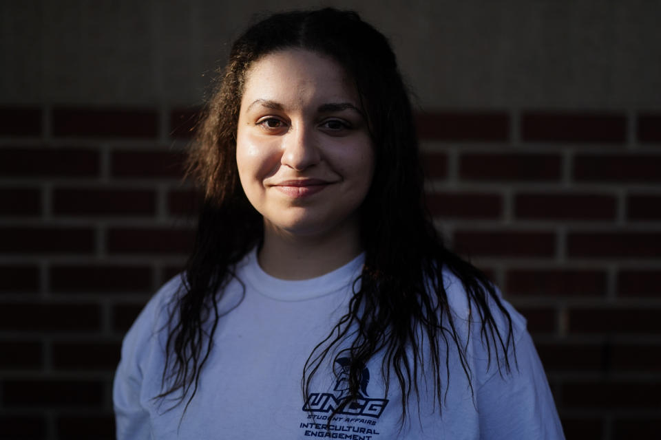 Laura Comino, a senior at the University of North Carolina at Greensboro poses for a picture on Tuesday, July 14, 2020, in Charlotte, N.C. College students are getting ready to return to school in August as the country deals with the coronavirus pandemic. More and more campuses are sparking frustration by releasing plans to keep students' housing payments, even if the campuses shut down again and go entirely online in the fall. (AP Photo/Chris Carlson)