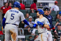 Los Angeles Dodgers' Trea Turner celebrates with Freddie Freeman (5) after Turner hit a home run, as Atlanta Braves catcher William Contreras watches during the fourth inning of a baseball game Friday, June 24, 2022, in Atlanta. (AP Photo/Butch Dill)