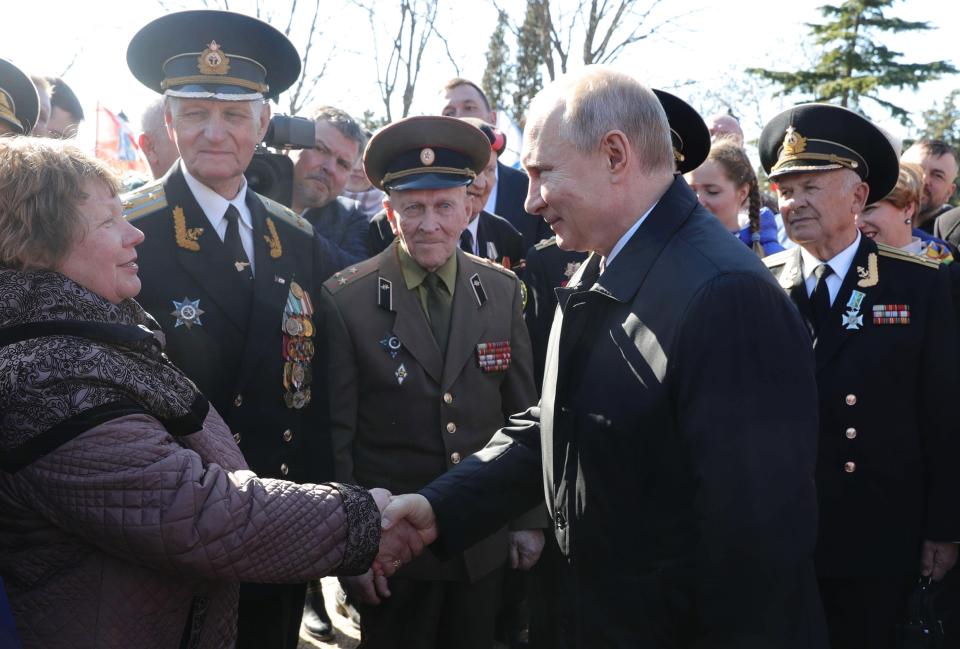 Russian President Vladimir Putin, right, meets with local residents and veterans at the historical memorial the Malakhov Kurgan (Malakoff redoubt) in Sevastopol, Crimea, Monday, March 18, 2019. Putin visited Crimea to mark the fifth anniversary of Russia's annexation of Crimea from Ukraine by visiting the Black Sea peninsula. (Mikhail Klimentyev, Sputnik, Kremlin Pool Photo via AP)