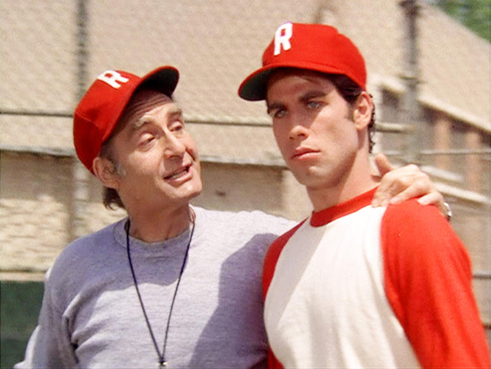 LOS ANGELES - JUNE 16: The movie "Grease", directed by Randal Kleiser. Seen here from left, Sid Caesar as Rydell High School Coach Calhoun and John Travolta as Danny Zuko. Initial theatrical release of the film, June 16, 1978. Screen capture. Paramount Pictures. (Photo by CBS via Getty Images)