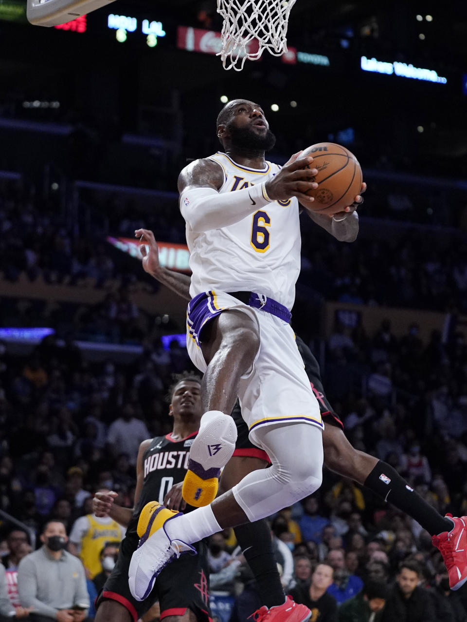 Los Angeles Lakers forward LeBron James, top, shoots as Houston Rockets guard Jalen Green, left, and guard Kevin Porter Jr. defend during the first half of an NBA basketball game Sunday, Oct. 31, 2021, in Los Angeles. (AP Photo/Mark J. Terrill)