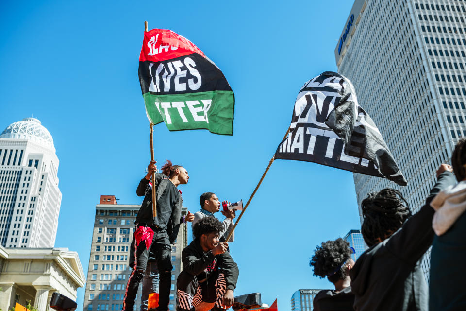 A group of protesters stand on a truck that is being used a road block near Jefferson Square Park on September 30, 2020 in Louisville, Kentucky. (Photo by Jon Cherry/Getty Images)