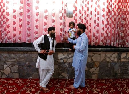 Afghan Sikh men talk to each other inside a Gurudwara, or a Sikh temple, during a religious ceremony in Kabul, Afghanistan June 8, 2016. REUTERS/Mohammad Ismail