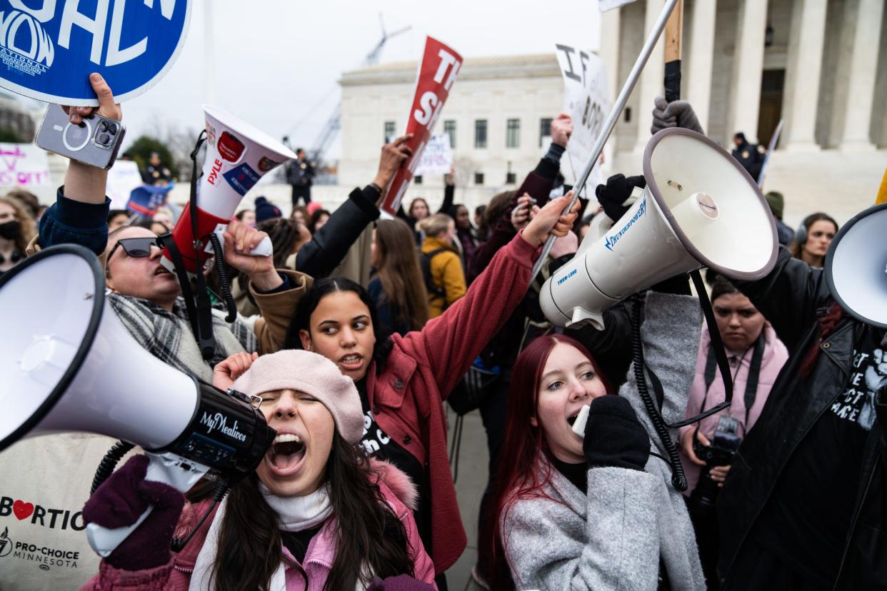 Abortion-rights and anti-abortion activists clash outside of the Supreme Court building after participants of the Women's March walked there from the White House on January 22, 2023.