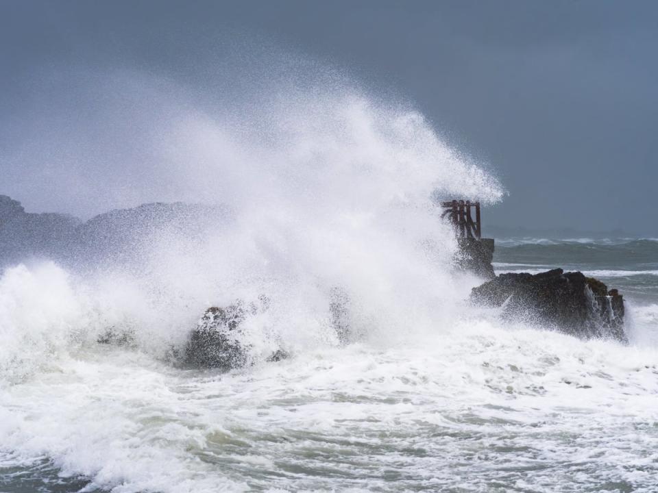 Waves hit rocks in Dublin (PA)