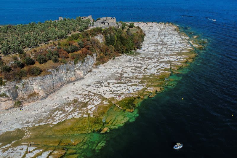 Rocky beach emerges from Lake Garda following severe drought