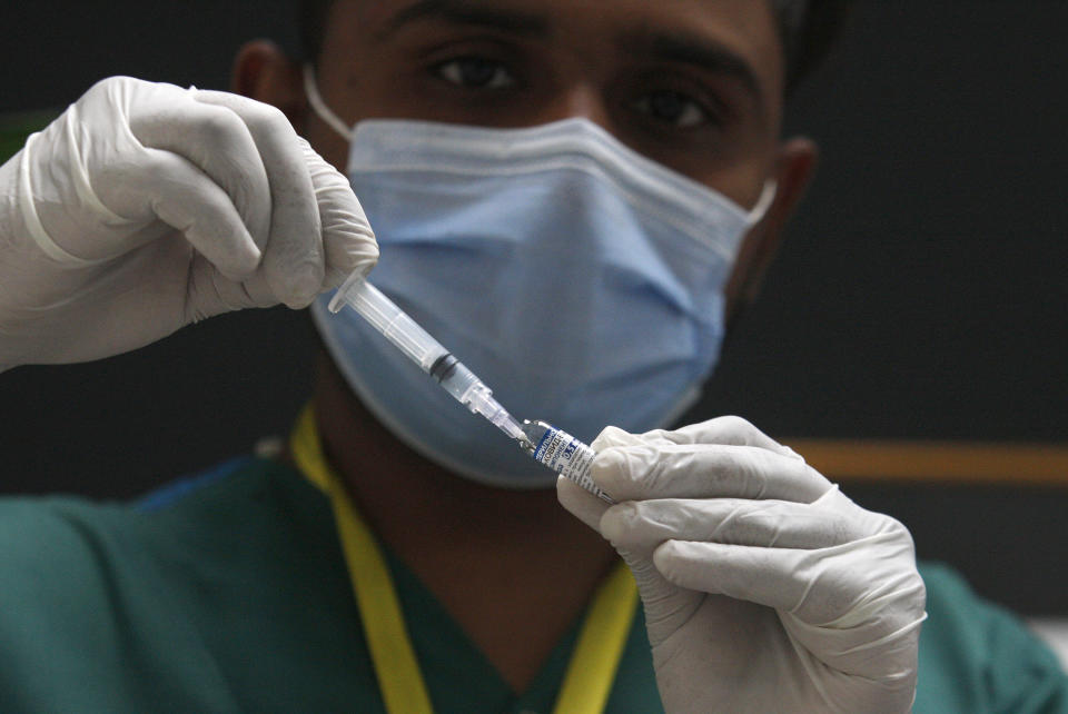 A health worker prepares a Sputnik V COVID-19 vaccine at a private hospital, in Karachi, Pakistan, Tuesday, April 6, 2021. (AP Photo/Fareed Khan)