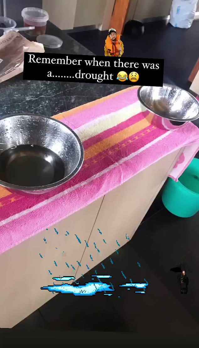 A still from a video of Sam Armytage's kitchen with bowls and buckets collecting leaking rain water