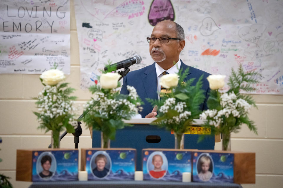 Deacon Regan Banks speaks during a memorial for brothers John-Mikal McLuer, 12, Odin-Thor McLuer, 10, Drako-Ragnar McLuer, 6, and Phenix-Moon McLuer, 3, who were lost in a November house fire.