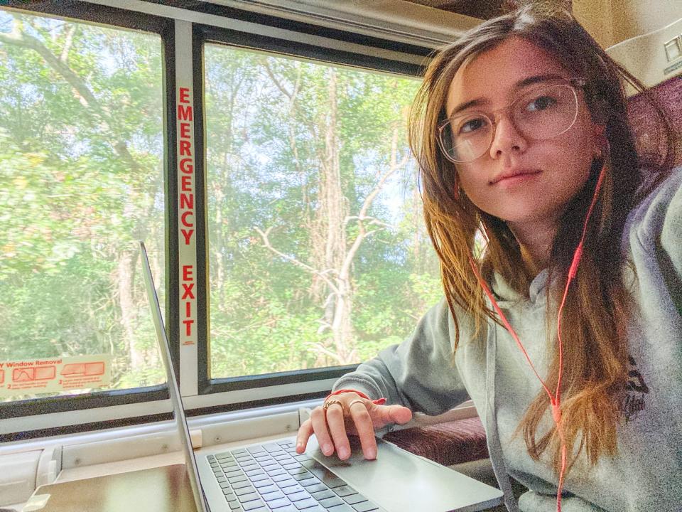 The author works on a laptop in a train car