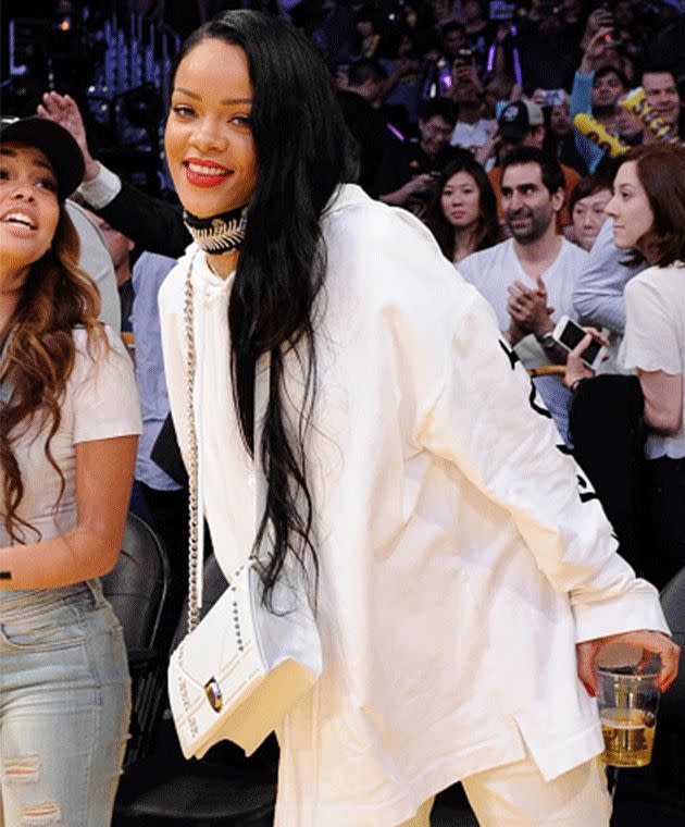 Rihanna at a Lakers game wearing her Dior purse around her neck. Photo: Getty Images
