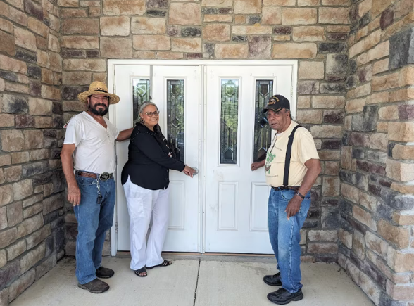 Victor Jacinto, Tyrese Gould Jacinto, president and CEO of the Native American Advancement Corporation, and her father, former Chief Mark “Quiet Hawk” Gould, in front of the former Morningstar Fellowship Church on Aug. 15. (photo/New Jersey Conservation Foundation)