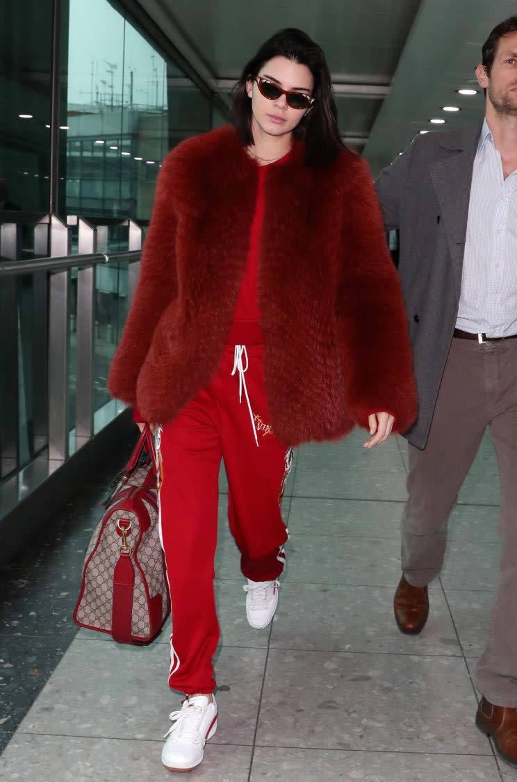 <i>Kendall wore a full red tracksuit to touch down at Heathrow [Photo: Rex]</i>