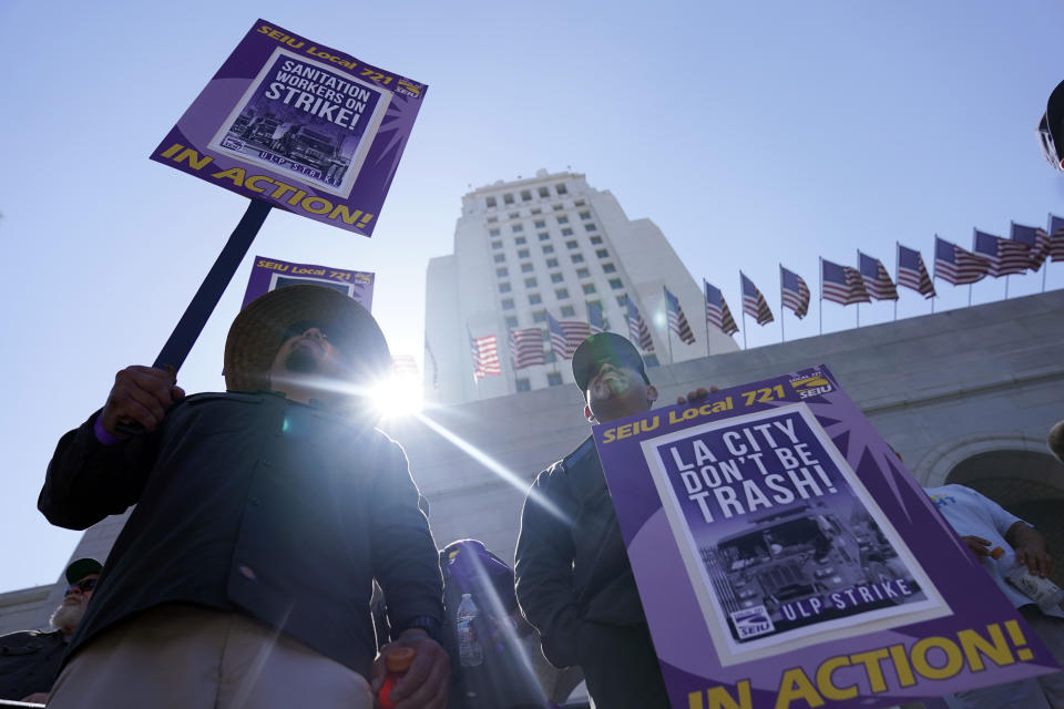 Workers picket outside of City Hall, Tuesday, Aug. 8, 2023, in Los Angeles. Thousands of Los Angeles city employees, including sanitation workers, lifeguards and traffic officers, walked off the job Tuesday for a 24-hour strike alleging unfair labor practices. (AP Photo/Ryan Sun)