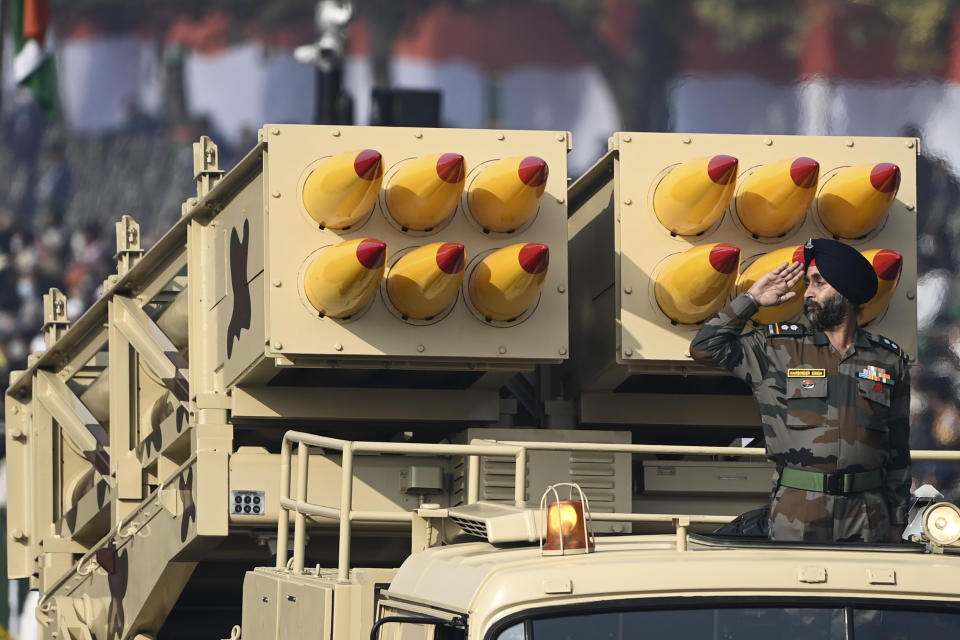 A soldier salutes from a Pinaka multi-barrel rocket launcher as they march along Rajpath during the Republic Day parade in New Delhi on January 26, 2021. (Photo by Jewel SAMAD / AFP) (Photo by JEWEL SAMAD/AFP via Getty Images)