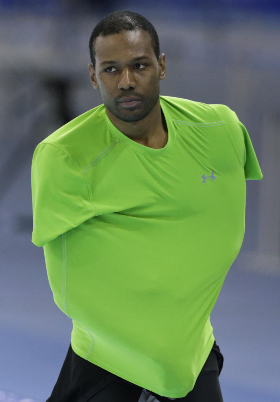 Shani Davis of the U.S. removes his training suit at the Adler Arena Skating Center during the 2014 Winter Olympics in Sochi, Russia, Friday, Feb. 7, 2014. (AP Photo/Matt Dunham)