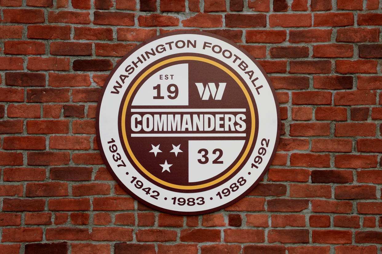 Commanders logo on a brick wall.