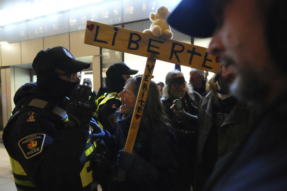 A protester confronts police during a demonstration, part of a convoy-style protest participants are calling "Rolling Thunder," in Ottawa, Ontario, Friday, April 29, 2022. (Sean Kilpatrick/The Canadian Press via AP)