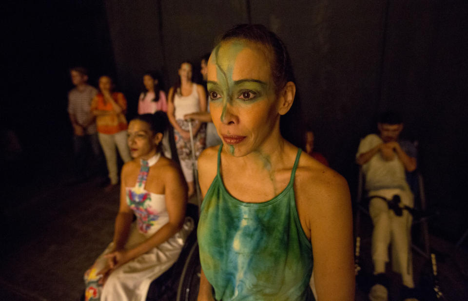 In this Dec. 4, 2018 photo, dancers watch their fellow dancers perform in the contemporary dance production Ubuntu, at the Teresa Carreno Theater in Caracas, Venezuela. During the show, disabled dancers perform alongside fully abled professional dancers to demonstrate that art knows no barriers. (AP Photo/Fernando Llano)