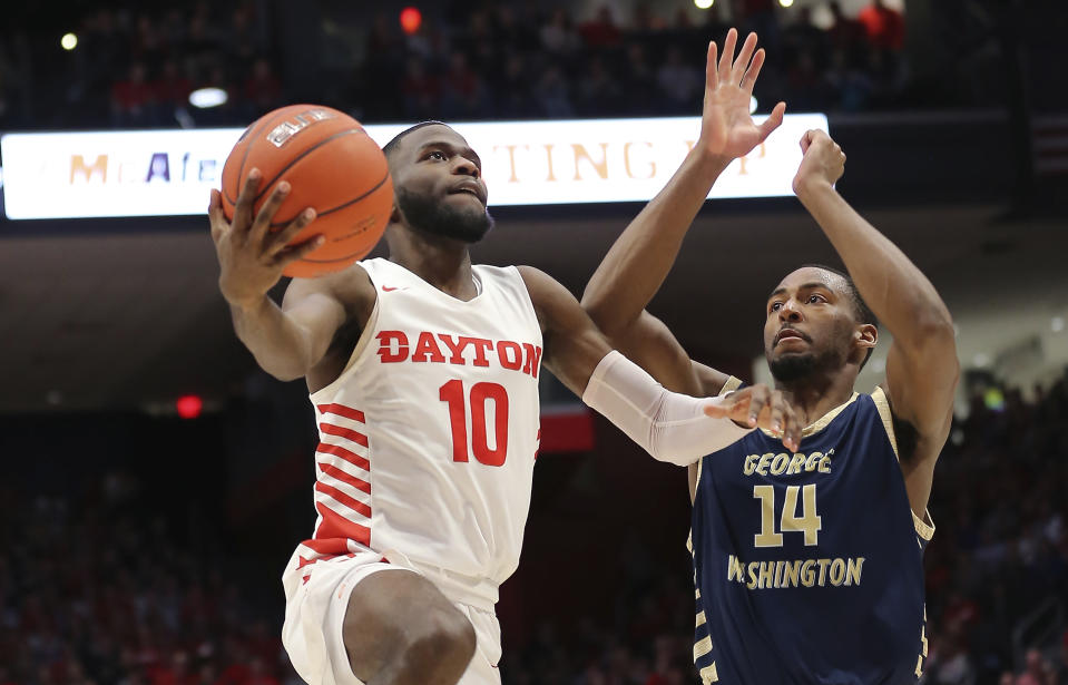 Dayton's Jalen Crutcher (10) drives to the basket against George Washington's Maceo Jack (14) during the second half of an NCAA college basketball game Saturday, March 7, 2020, in Dayton, Ohio. (AP Photo/Tony Tribble)