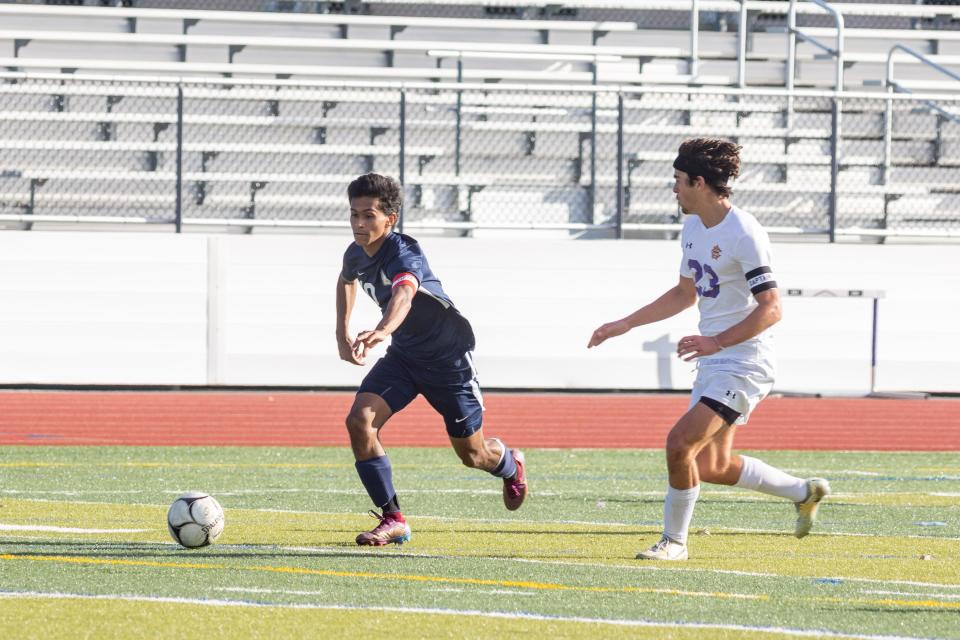 Beacon's Andre Alzate chases the ball in the New York State Class A soccer semifinals in Monroe on November 12, 2022.