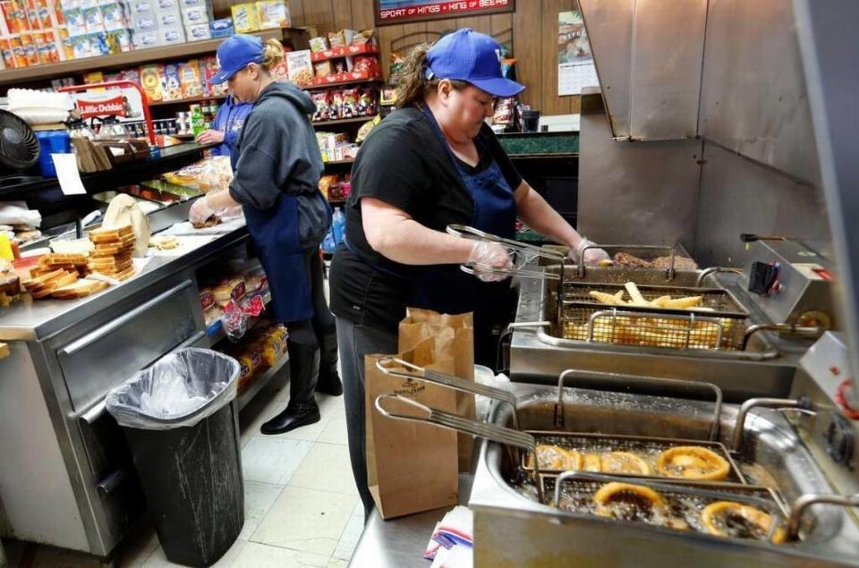 Christina King, left, and Delores Hager, right, cooked at the C & P Market and Grill on Manchester Street, which serves breakfast and lunch.