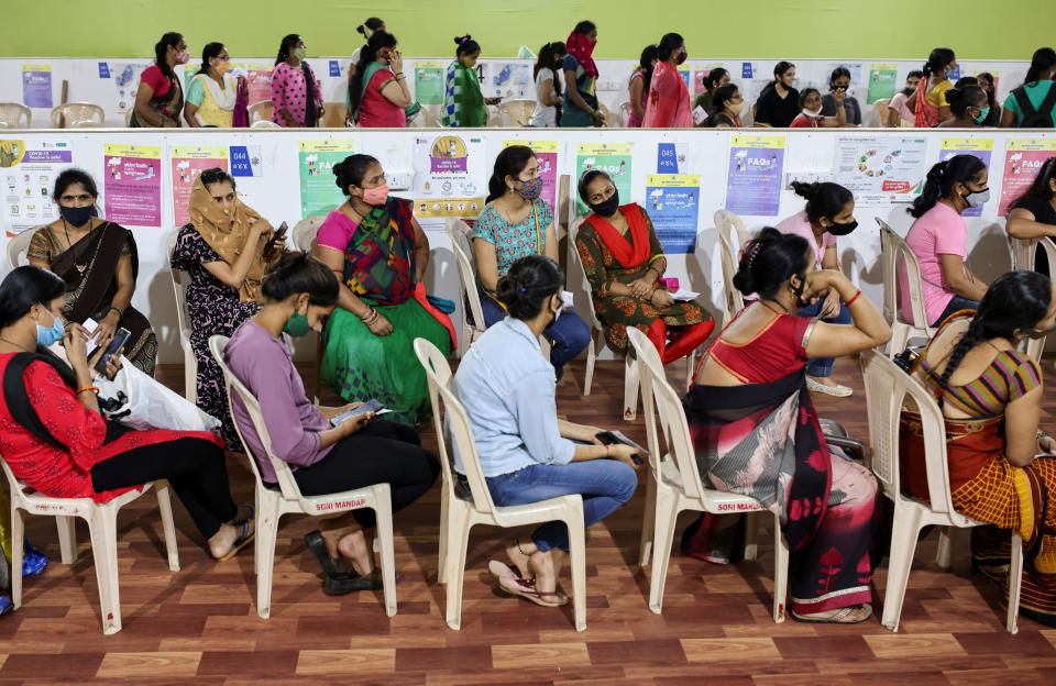 Women wait to receive a dose of AstraZeneca's COVISHIELD vaccine, produced by the Serum Institute of India, during a special coronavirus disease (COVID-19) vaccination campaign for women at a medical centre in Mumbai, India, September 27, 2021. REUTERS/Francis Mascarenhas