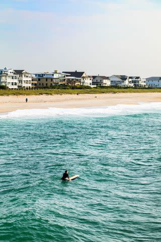 <p>LISA CORSON</p> A surfer scans the sea at Wrightsville Beach.