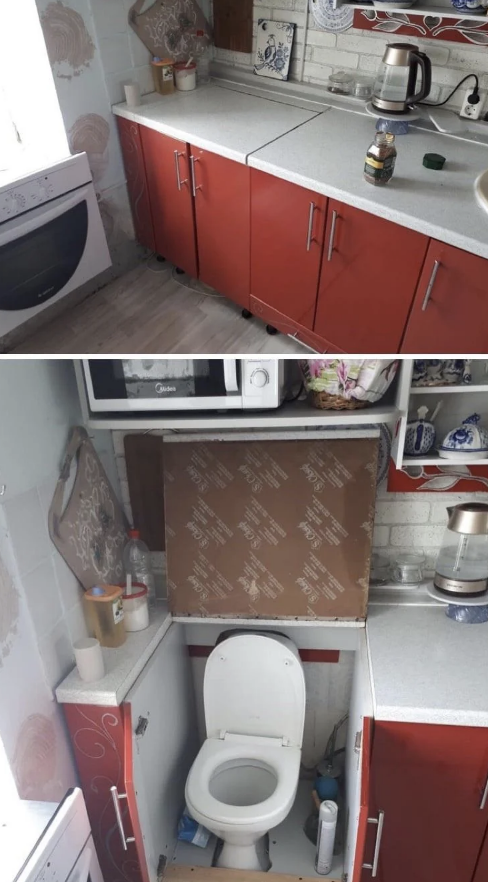 A kitchen with red cabinets and a toilet incorrectly installed under the counter.