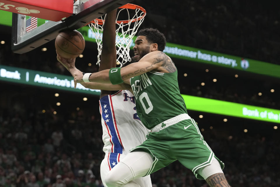 Boston Celtics forward Jason Tatum (0) leads toward the basket as Joel Embiid of the Philadelphia 76ers defends, behind him, during the second half of Game 7 in the NBA Semifinals Playoff Series, Sunday, May 14, 2023, in Boston.  (AP Photo/Steven Senne)